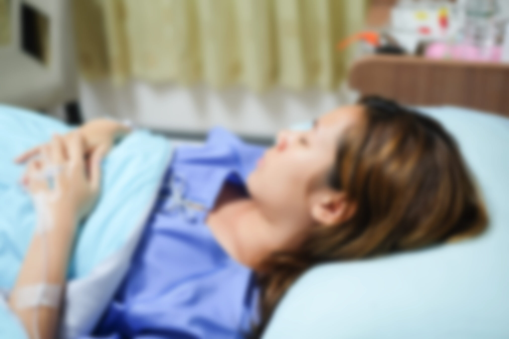 Recovery and Rest after Arm Lift Surgery Image on Dr Carmen Munteanu Blog - Woman in Hospital Scrub Sleeping